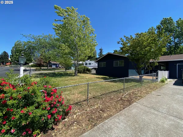 a view of a house with a yard and sitting area