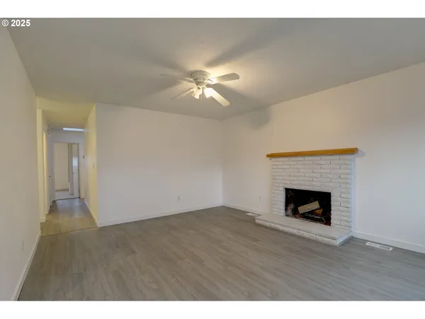 a view of empty room with a fireplace
