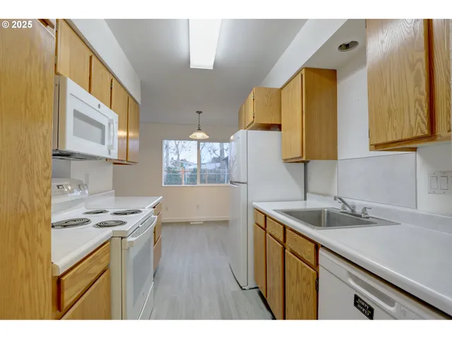 a kitchen that has a sink and a stove