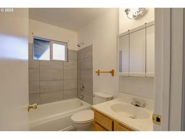 a bathroom with a sink a bath tub a shower and a sink