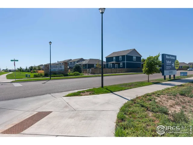 a view of a house with a yard and a street