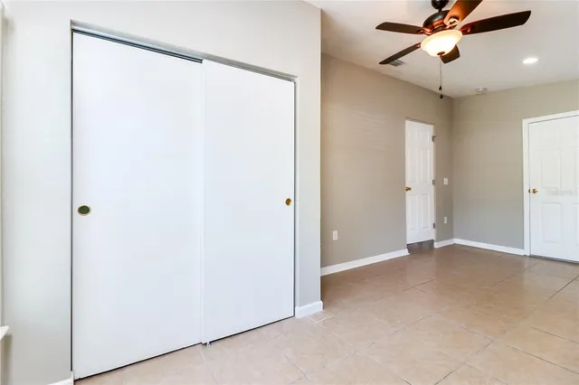 a view of an empty room with a fan