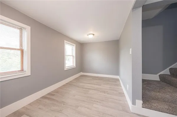 an empty room with windows and closet