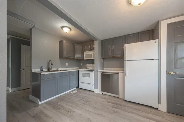 a kitchen with a refrigerator stove and sink