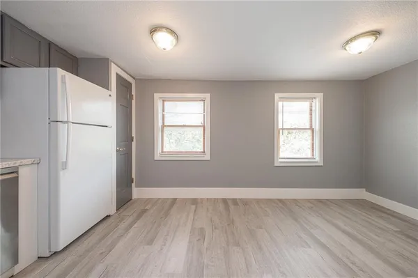 a view of a livingroom with wooden floor and a window