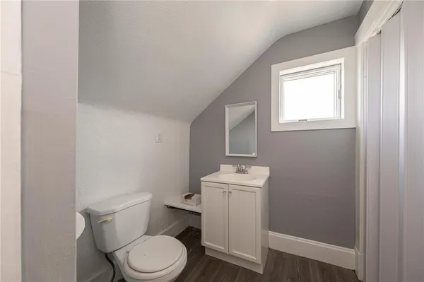 a white toilet sitting next to a bathroom sink