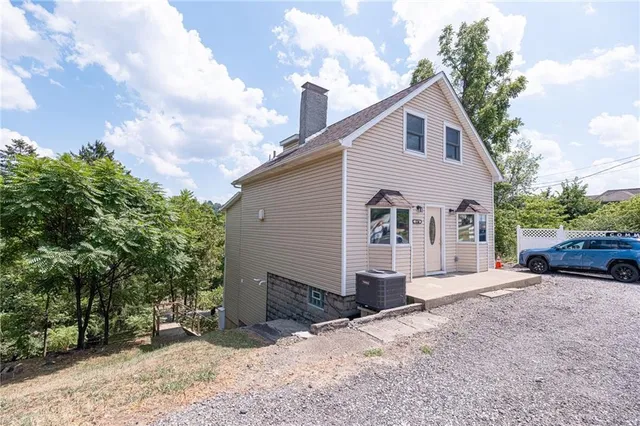 a view of a house with a yard and garage