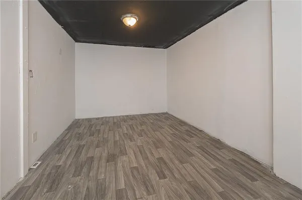 a view of a room with wooden floor