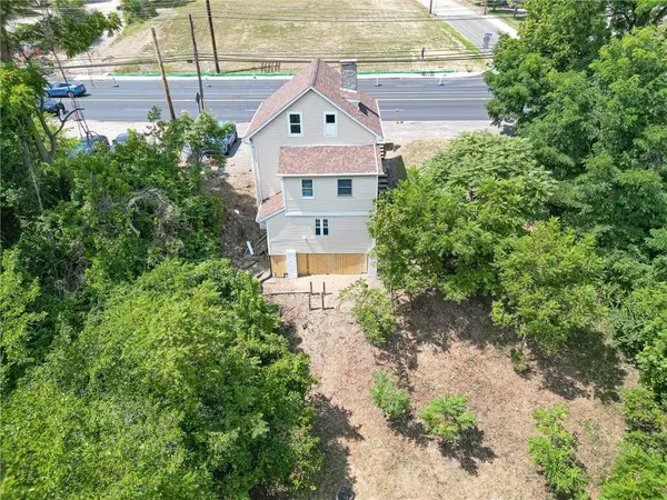 an aerial view of a house with a yard