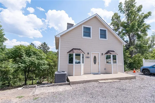 a view of a house with a yard and garage