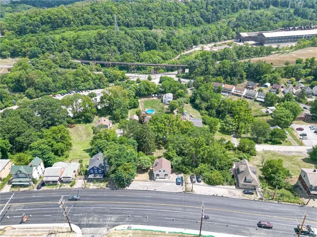 an aerial view of a houses with yard