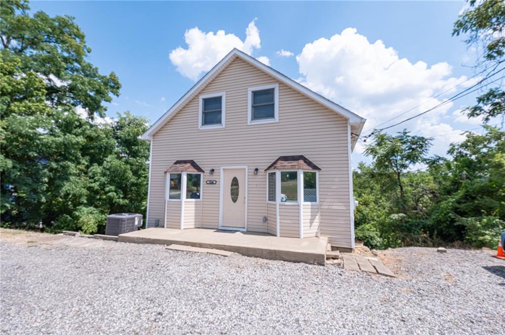 1214 Washington Pike Bridgeville, PA 15017 - Photo 4 of 39 a front view of a house with a yard and garage