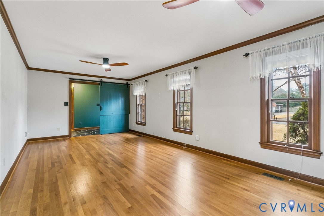 504 Meadowfield Road Yorktown, VA 23692 - Photo 11 of 45 a view of an empty room with window and wooden floor