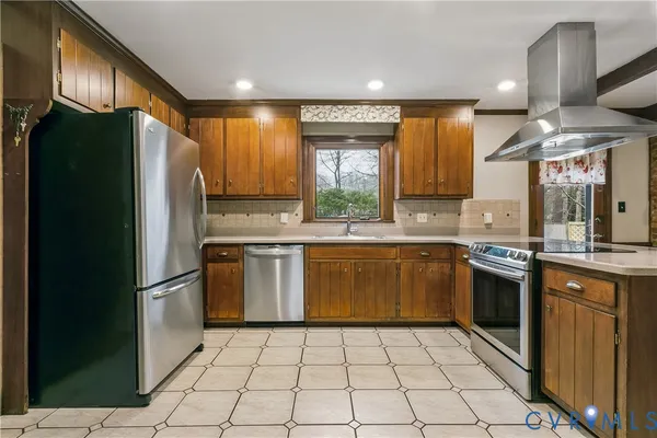 a kitchen with stainless steel appliances kitchen island granite countertop a sink and cabinets