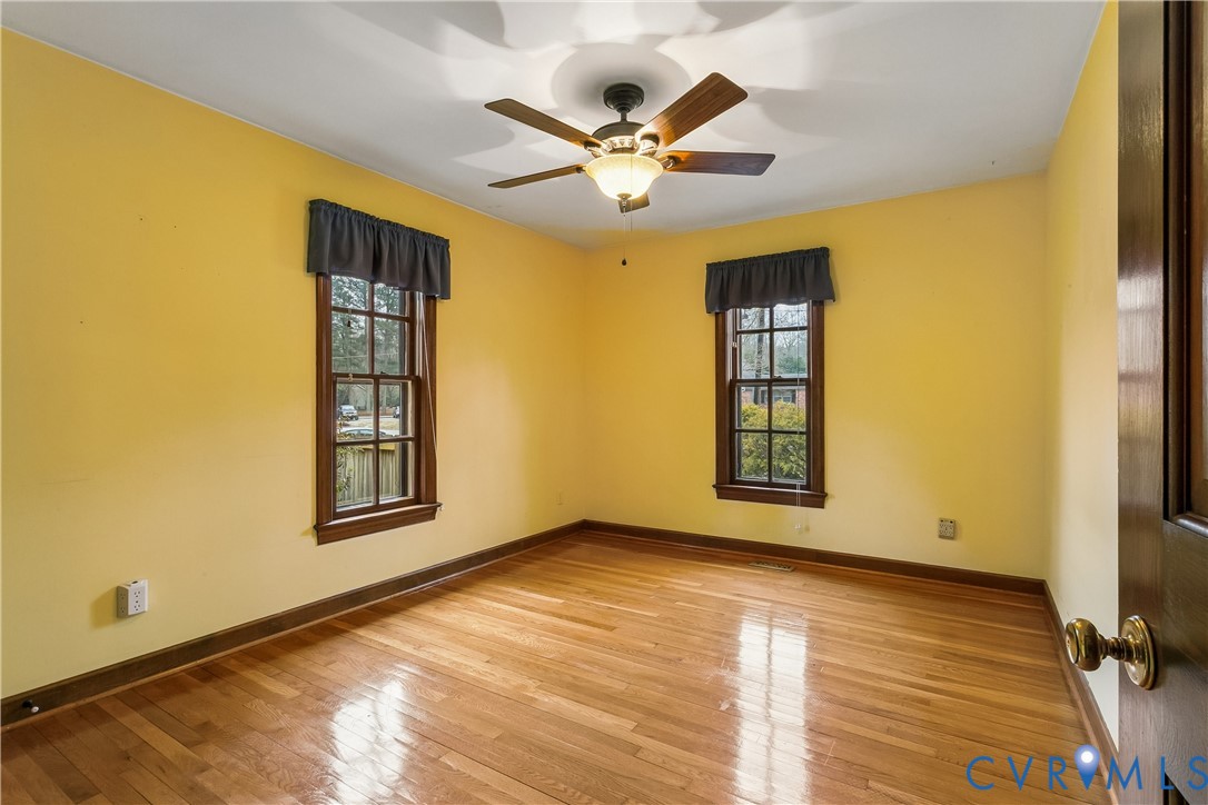 504 Meadowfield Road Yorktown, VA 23692 - Photo 25 of 45 a view of an empty room with a window and wooden floor