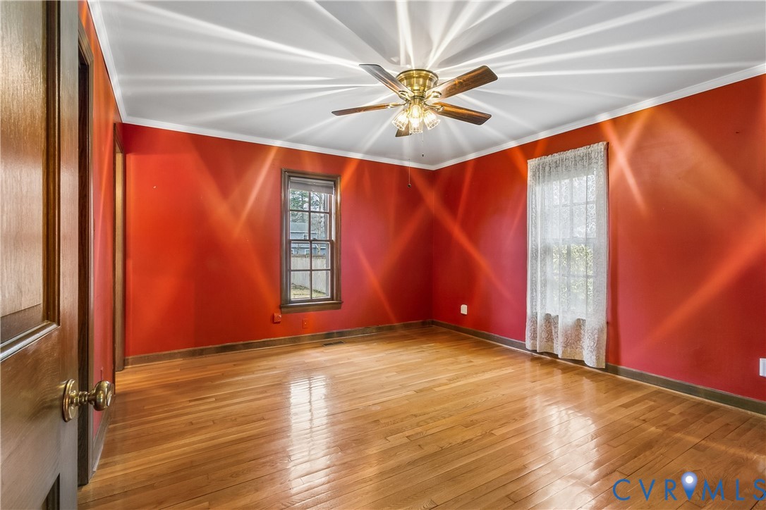 504 Meadowfield Road Yorktown, VA 23692 - Photo 27 of 45 an empty room with windows and fan