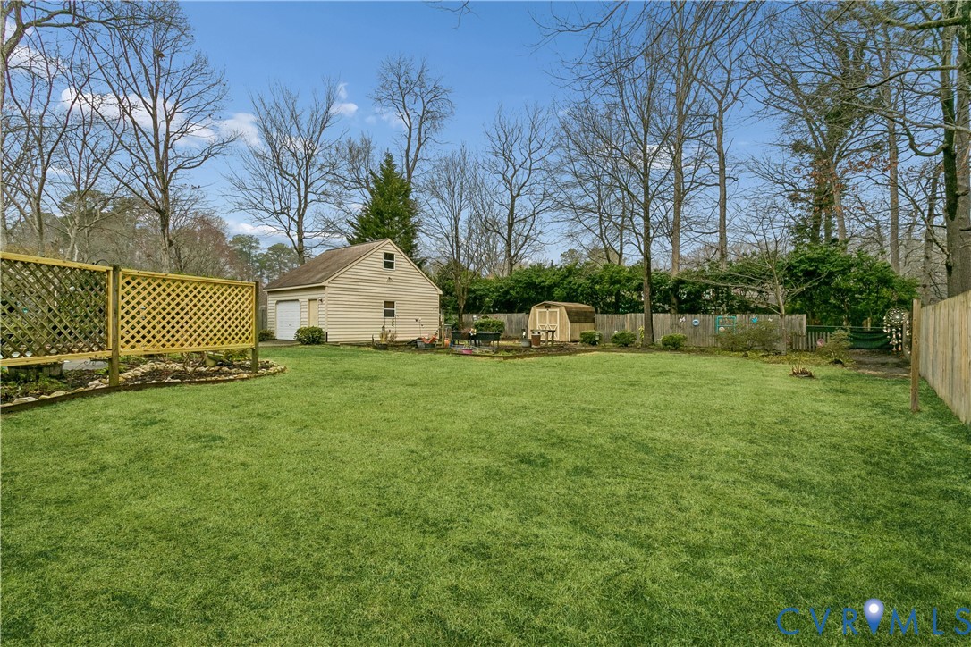 504 Meadowfield Road Yorktown, VA 23692 - Photo 38 of 45 a view of a white house with a yard and a large tree