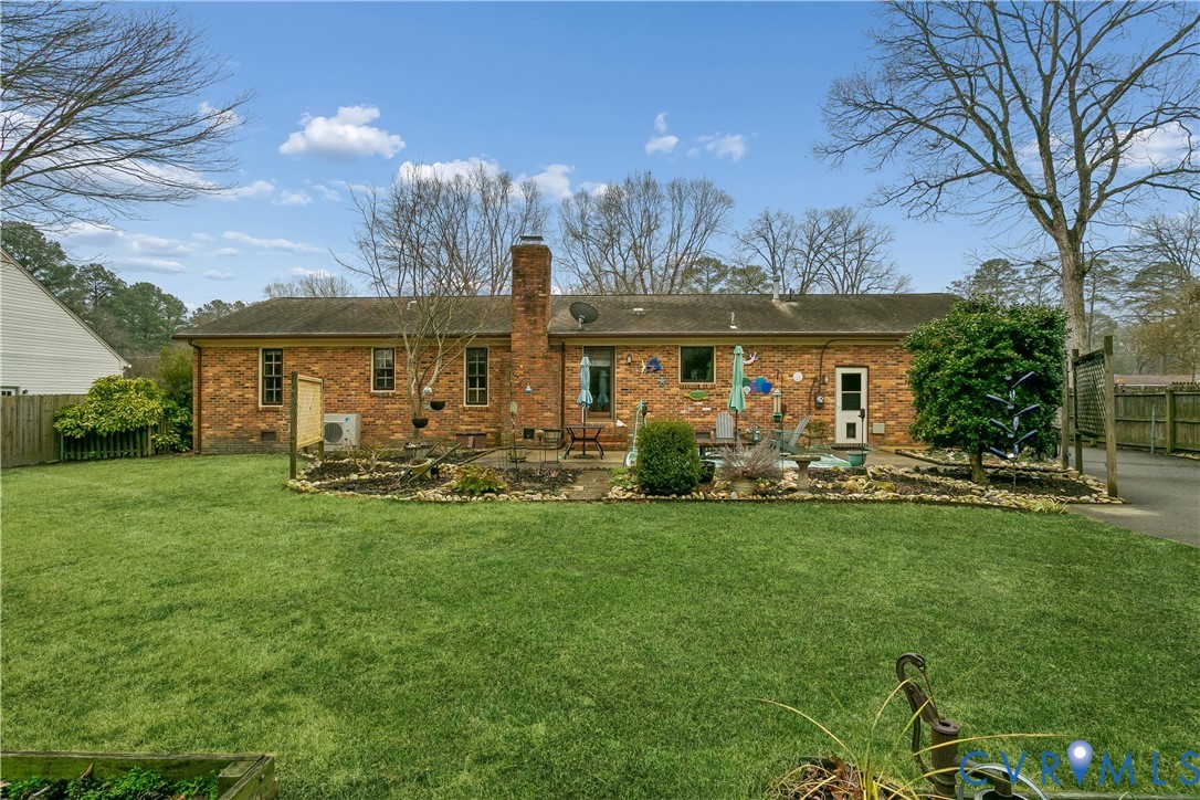 504 Meadowfield Road Yorktown, VA 23692 - Photo 42 of 45 a view of a house with a yard table and chairs
