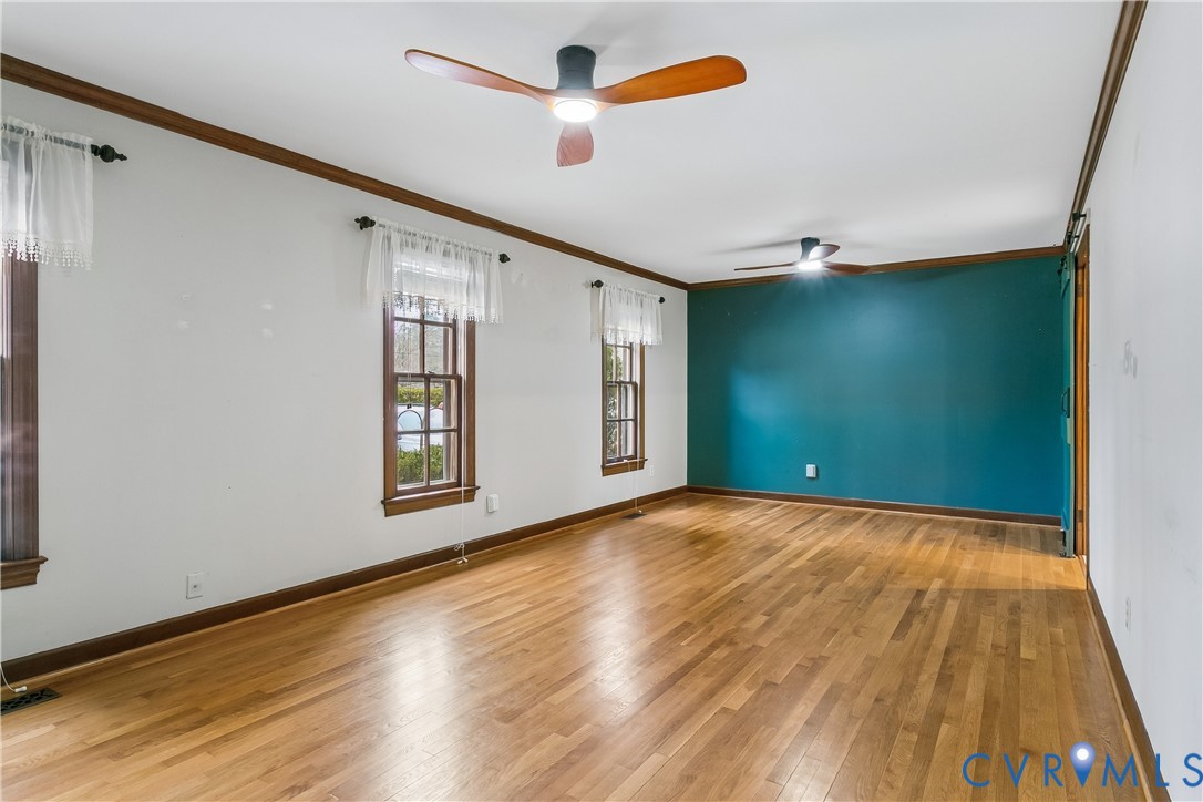 504 Meadowfield Road Yorktown, VA 23692 - Photo 9 of 45 a view of an empty room with window and wooden floor