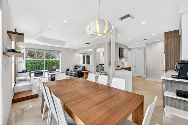 a large kitchen with a table and chairs