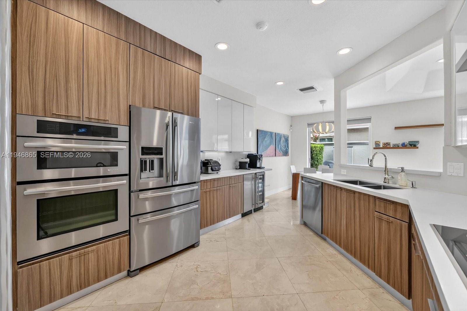 1469 Shoreline Way Hollywood, FL 33019 - Photo 13 of 46 a kitchen with stainless steel appliances a stove sink microwave and cabinets