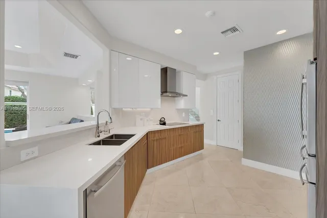 a kitchen with stainless steel appliances a sink stove and cabinets