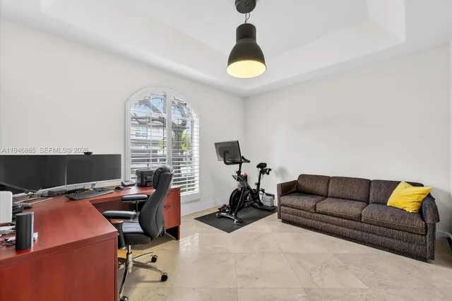 a view of a livingroom with workspace and a window