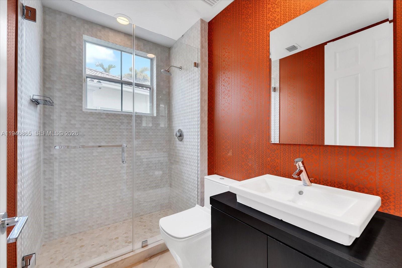 1469 Shoreline Way Hollywood, FL 33019 - Photo 16 of 46 a bathroom with a sink a toilet and shower