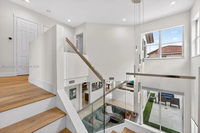 a view of entryway and hall with wooden floor