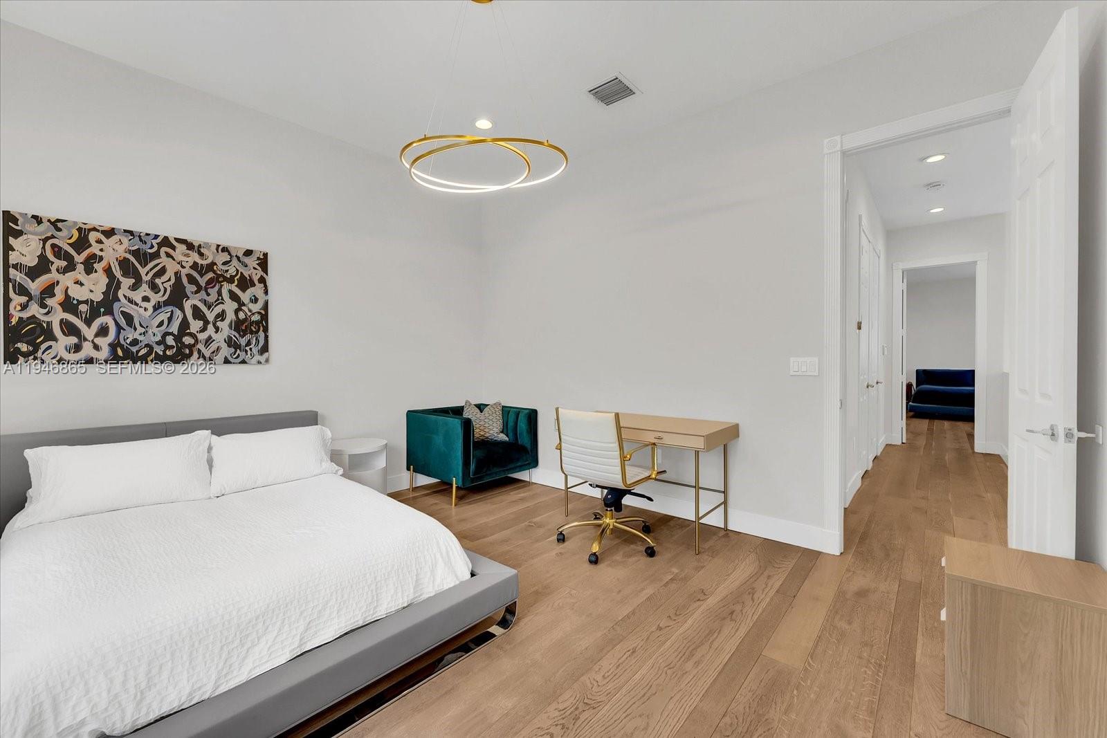 1469 Shoreline Way Hollywood, FL 33019 - Photo 19 of 46 a bedroom with a bed and a chair