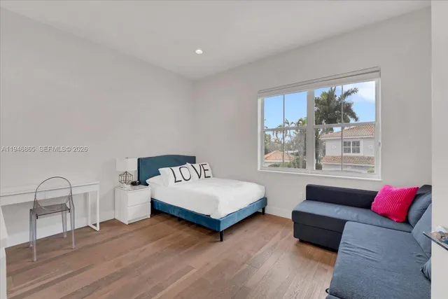 a spacious bedroom with a bed and a window