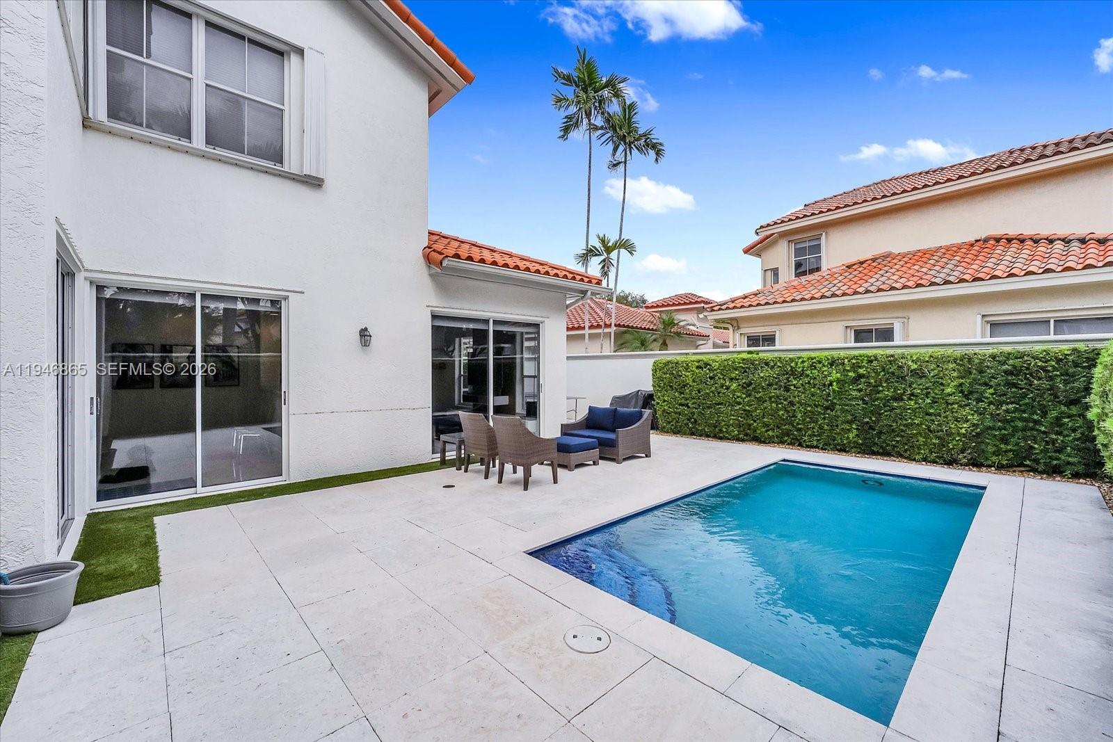 1469 Shoreline Way Hollywood, FL 33019 - Photo 2 of 46 a view of a porch with chairs and potted plants
