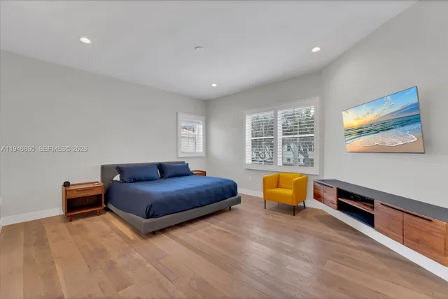 a bedroom with furniture and window