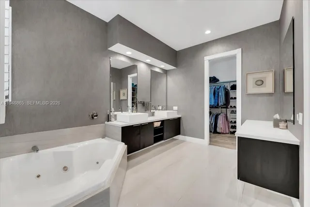 a large bathroom with a tub a sink double vanity and a mirror