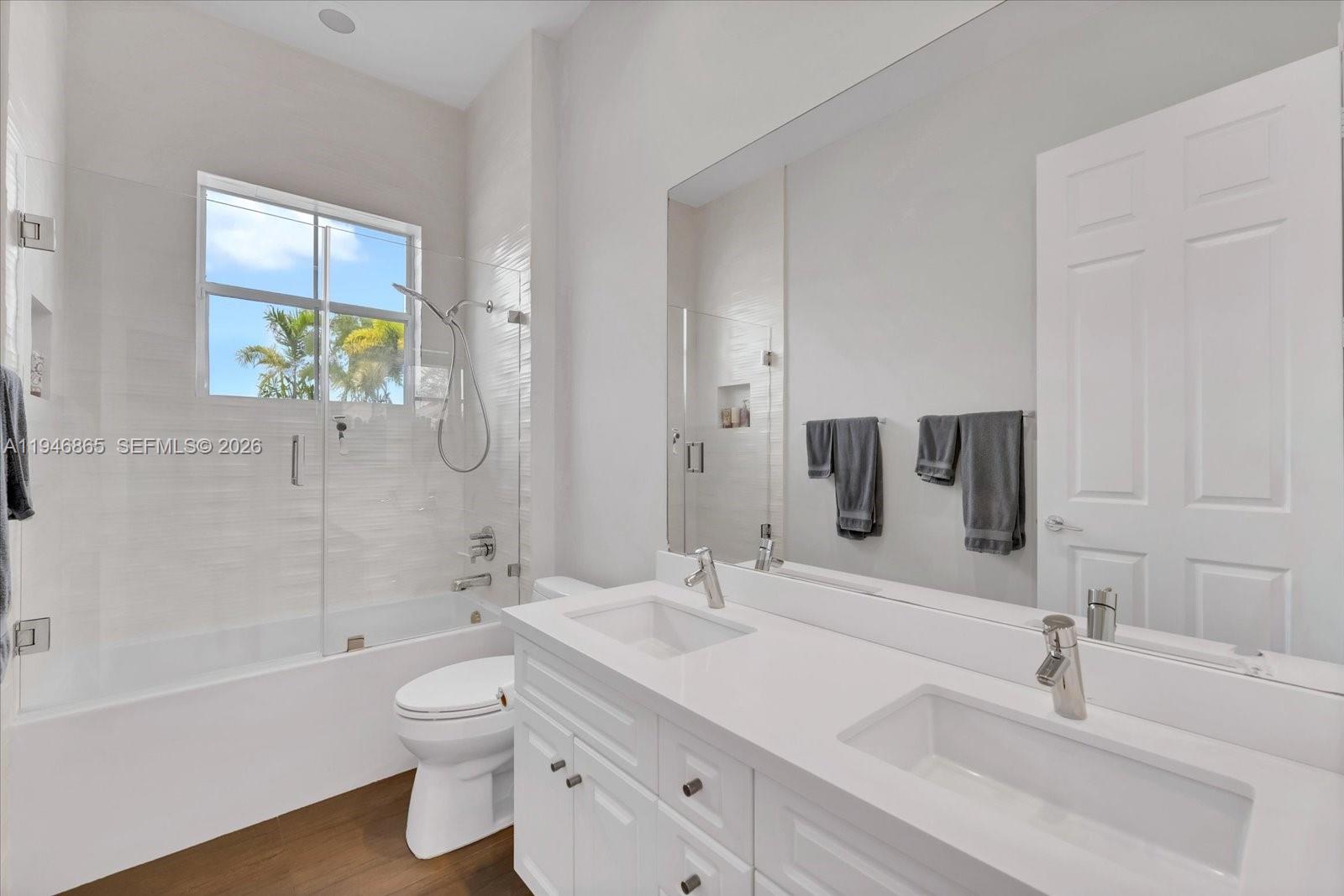 1469 Shoreline Way Hollywood, FL 33019 - Photo 27 of 46 a bathroom with a double vanity sink toilet and shower