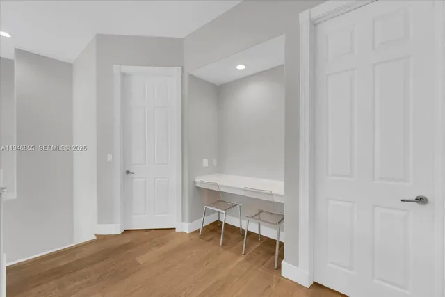 a view of a room with a wooden table and chair