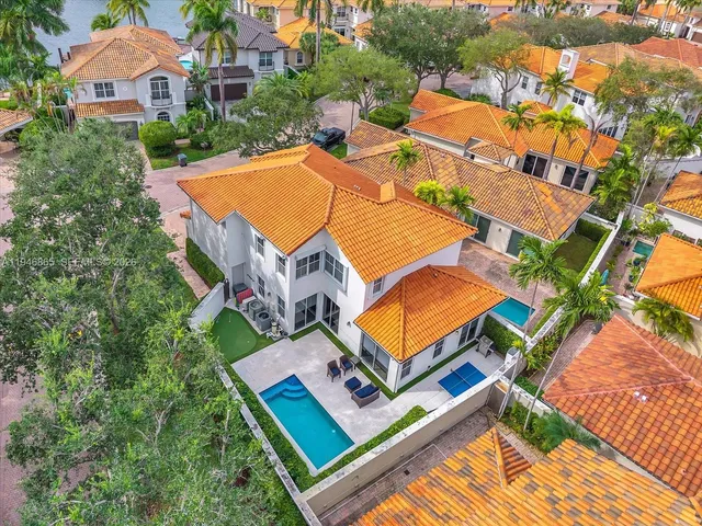 an aerial view of a house with swimming pool and outdoor space
