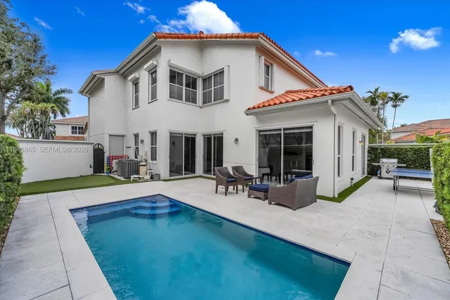 a view of a house with sitting area and chairs