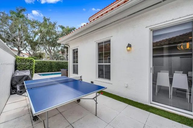 a view of backyard with outdoor seating and plants
