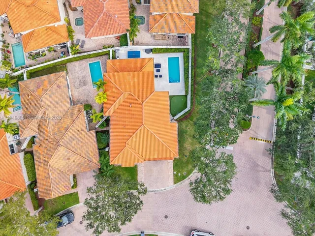 an aerial view of a house with a yard and sitting area
