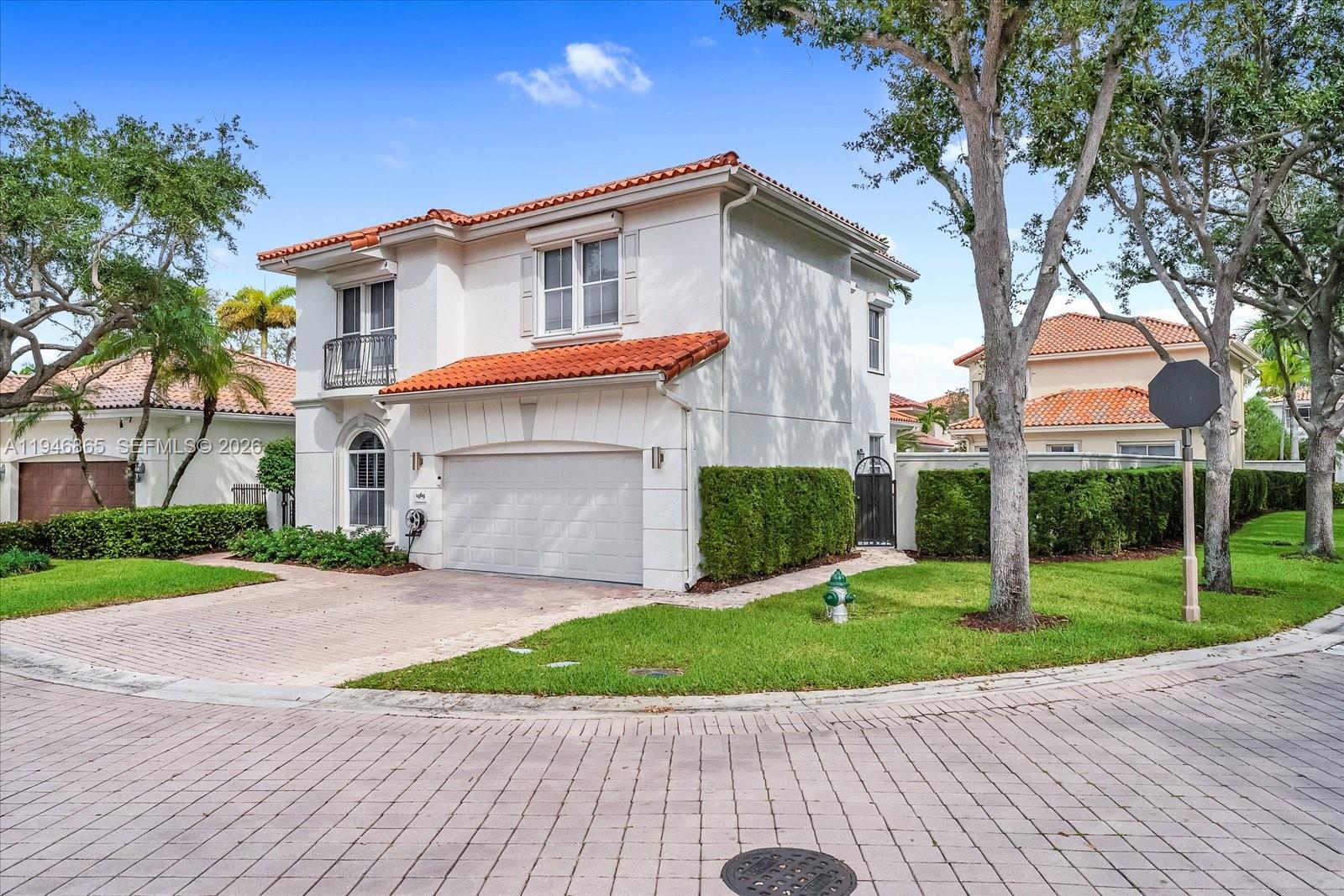 1469 Shoreline Way Hollywood, FL 33019 - Photo 5 of 46 a front view of a house with a yard and trees