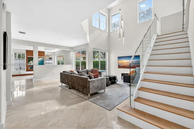 a living room with furniture and a chandelier