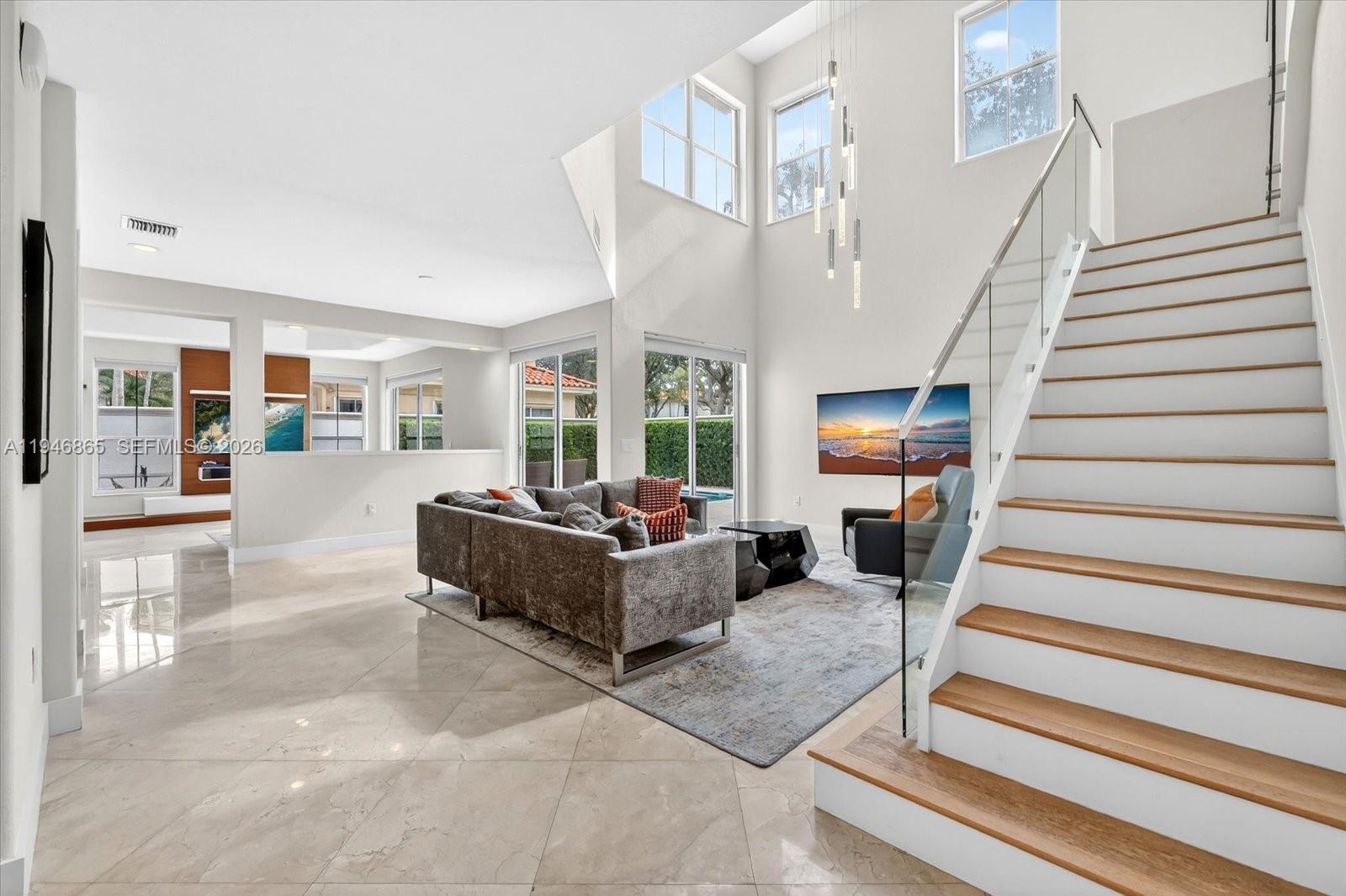 1469 Shoreline Way Hollywood, FL 33019 - Photo 6 of 46 a living room with furniture and a chandelier