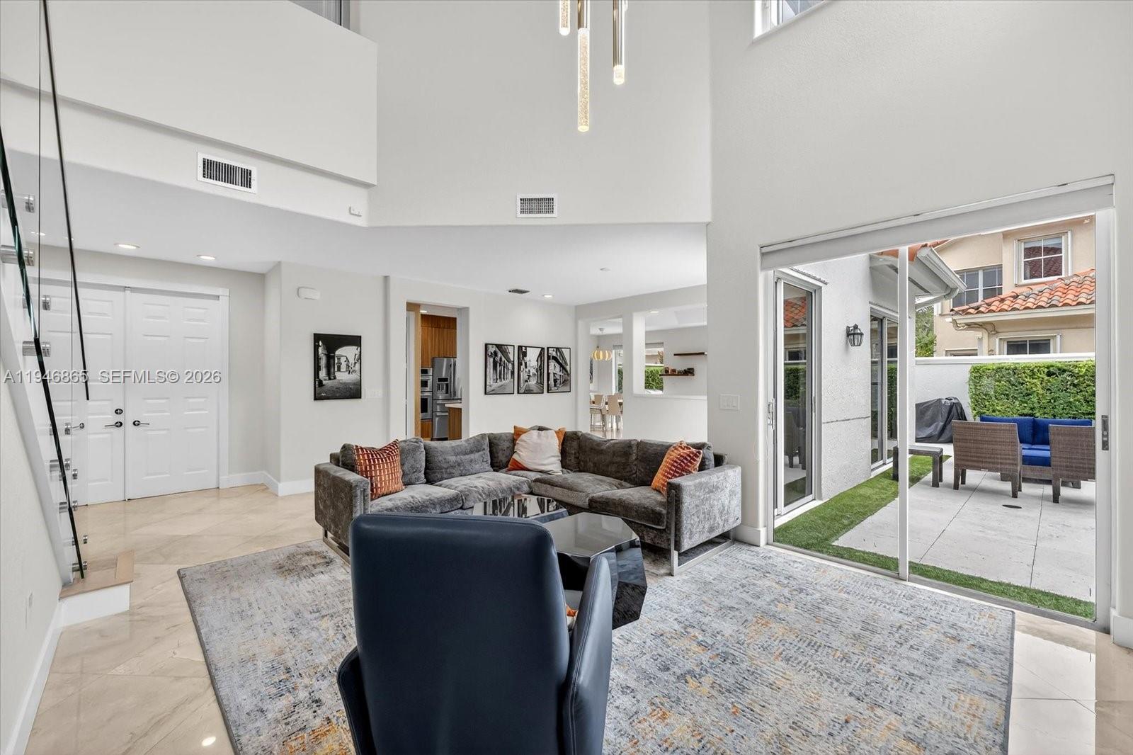 1469 Shoreline Way Hollywood, FL 33019 - Photo 8 of 46 a living room with furniture and a large window