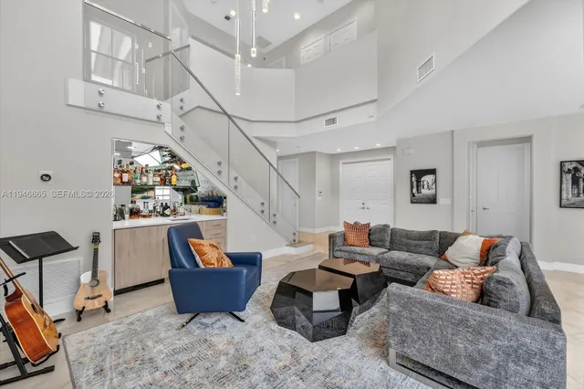 a living room with furniture and a chandelier
