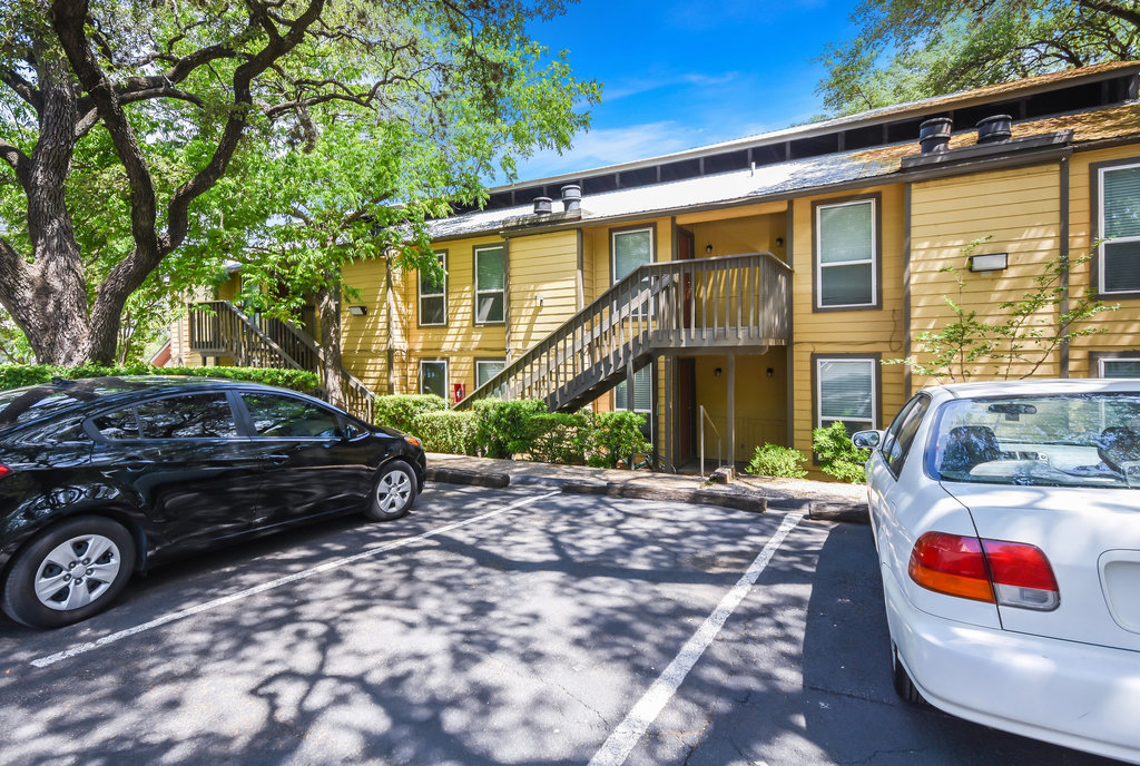 1000 West 26th Street, Unit 114 Austin, TX 78705 - Photo 18 of 20 a view of a car park in front of a house