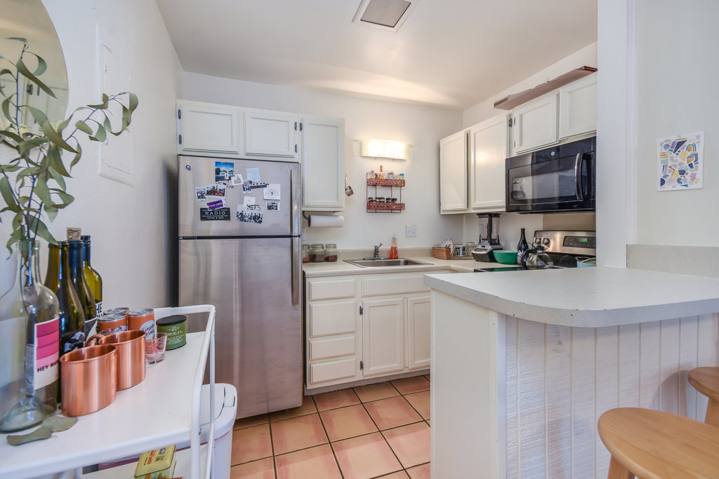 1000 West 26th Street, Unit 114 Austin, TX 78705 - Photo 4 of 20 a kitchen with stainless steel appliances a refrigerator sink and microwave