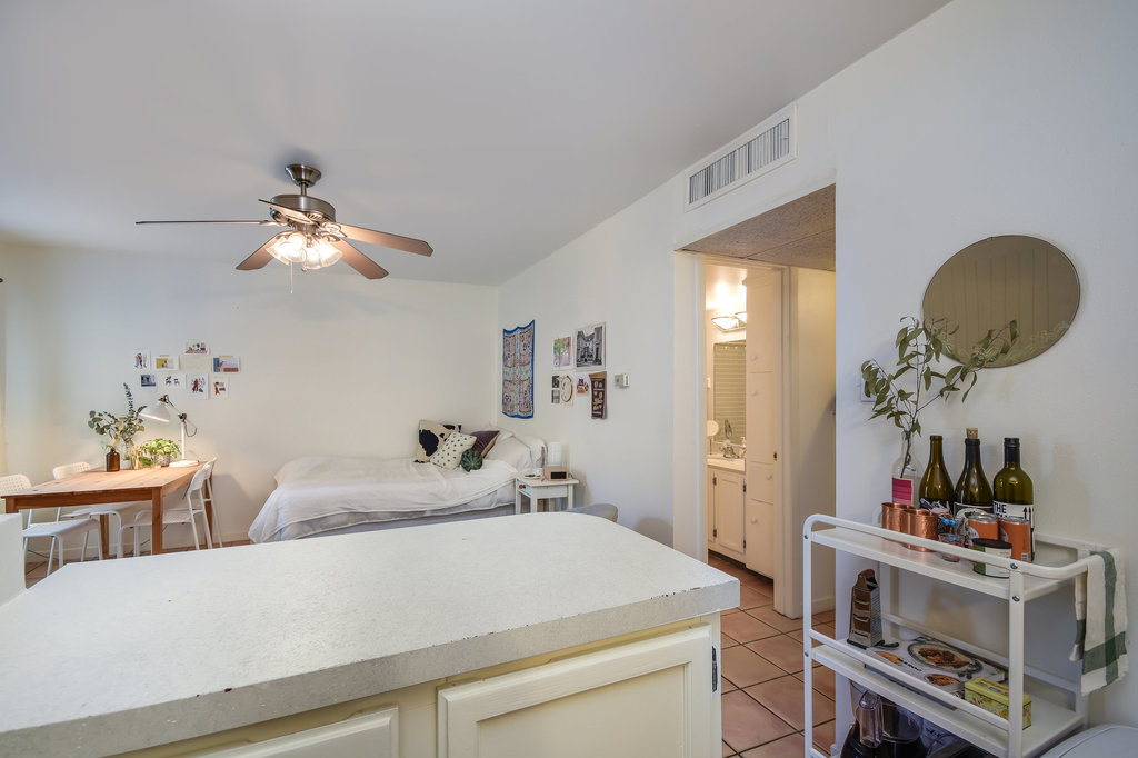1000 West 26th Street, Unit 114 Austin, TX 78705 - Photo 7 of 20 a living room with a baby bed furniture and a chandelier