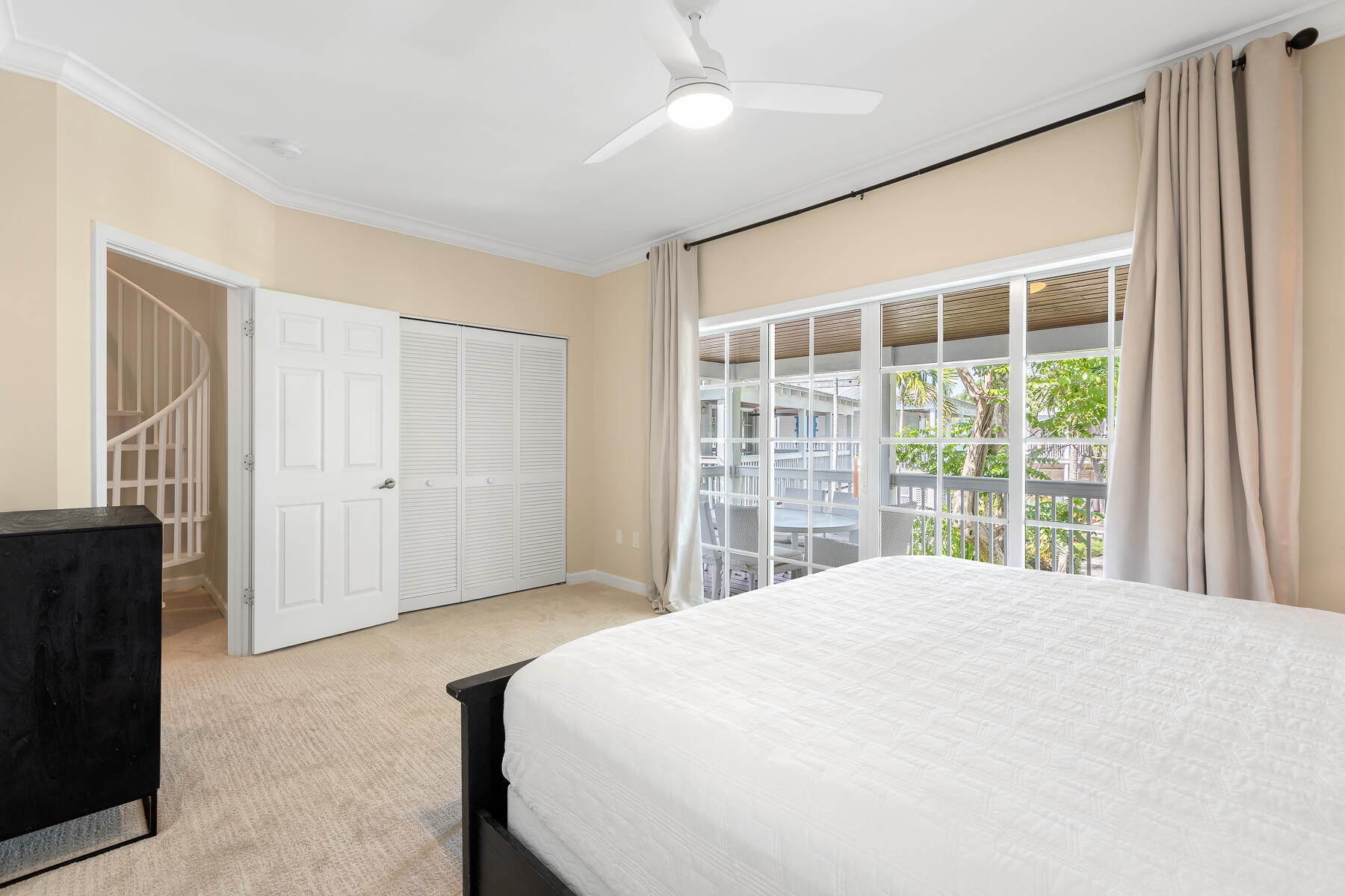 63 Sunset Key Drive Key West, FL 33040 - Photo 23 of 47 a large bed sitting in a bedroom next to a window