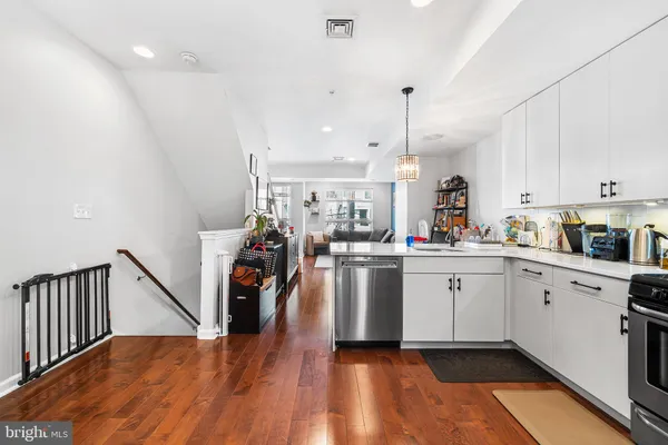 a kitchen with stainless steel appliances granite countertop a refrigerator sink and microwave